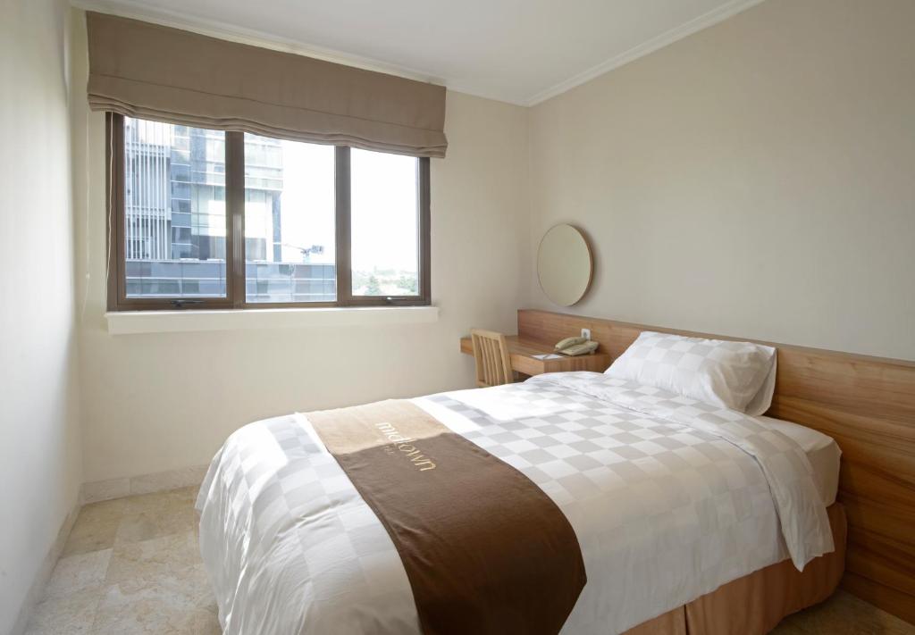 Postel nebo postele na pokoji v ubytování Midtown Residence Simatupang Jakarta