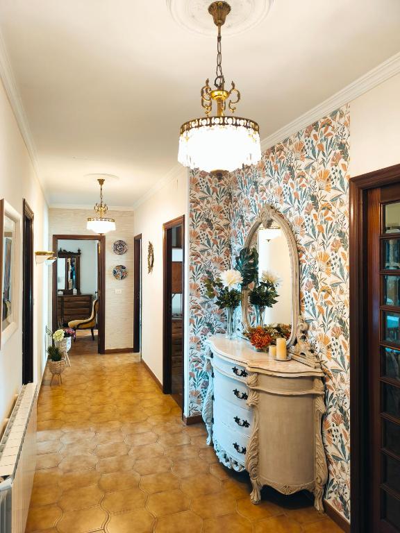 a hallway with a bathroom with a vanity and a mirror at Arrochela apartamento in Ribeira