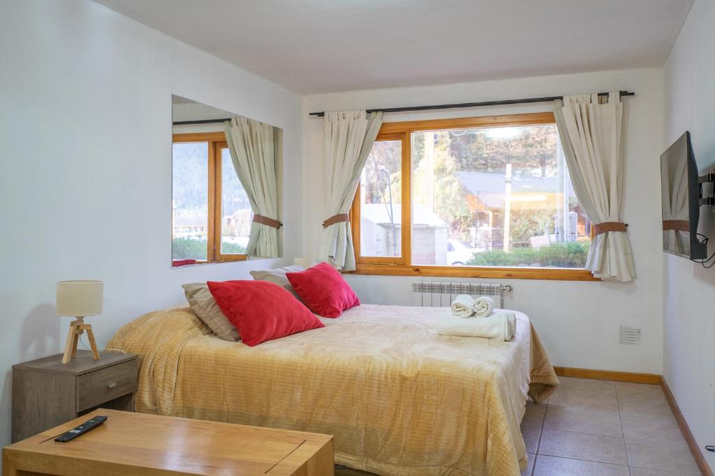 a bedroom with a bed with a teddy bear on it at Depto Del lago, con la mejor vista y cercano a todo - Ayres del Bosque Alojamientos in San Martín de los Andes