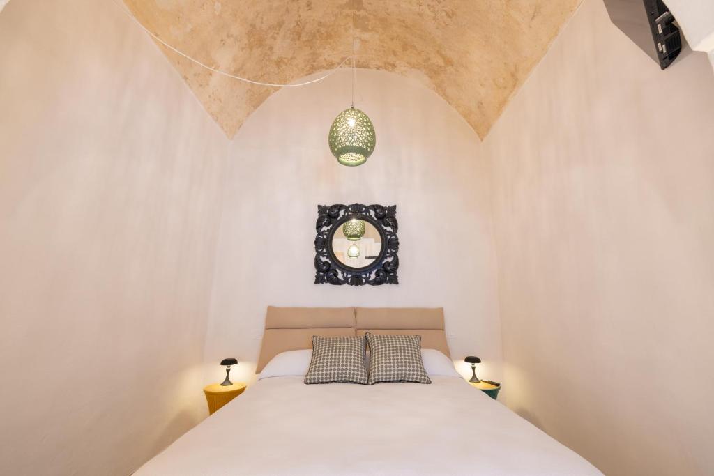 a bedroom with a bed with two pillows at Casa Annunziata Guest House in Ruffano