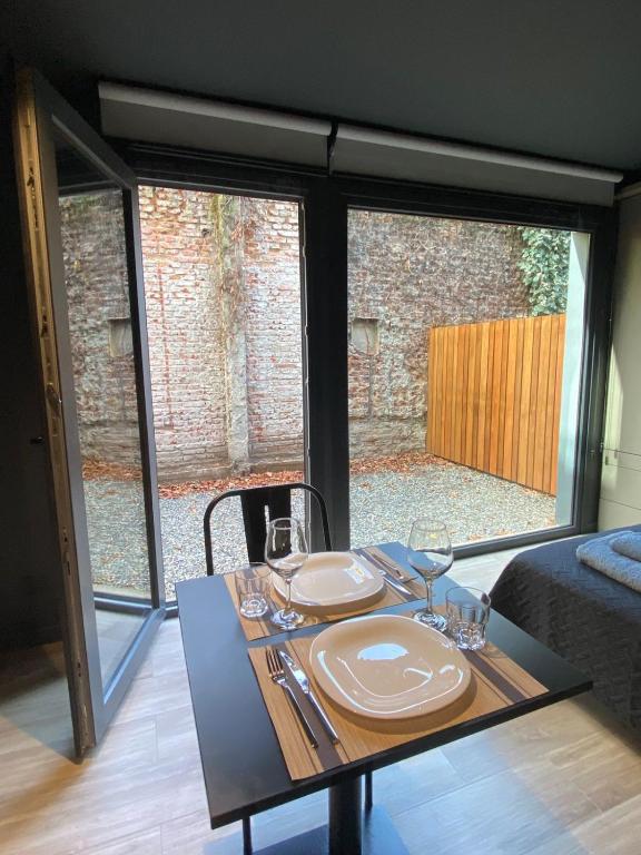 a dining room table with plates and glasses on it at Edificio Pantera - monoambiente 6 in San Martín de los Andes