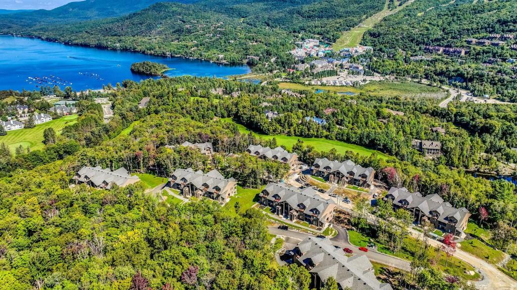 an aerial view of a mansion with a lake at Verbier by Tremblant Platinum in Mont-Tremblant