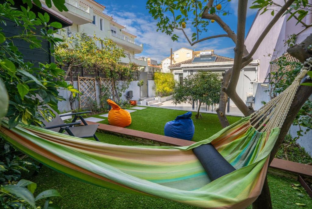 a hammock in a yard with three colorfulinylinylinylinylinylinylinyl at Argostoli Haven - Luxury House in Argostoli