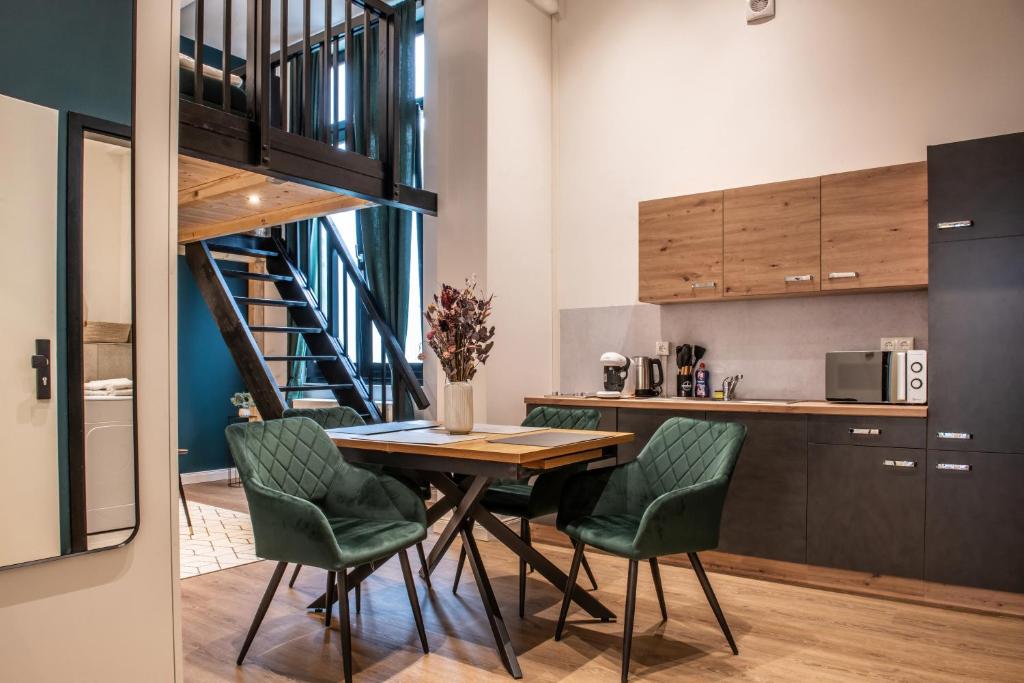 a kitchen and dining room with a table and chairs at Oran Apartment 3 in Berlin