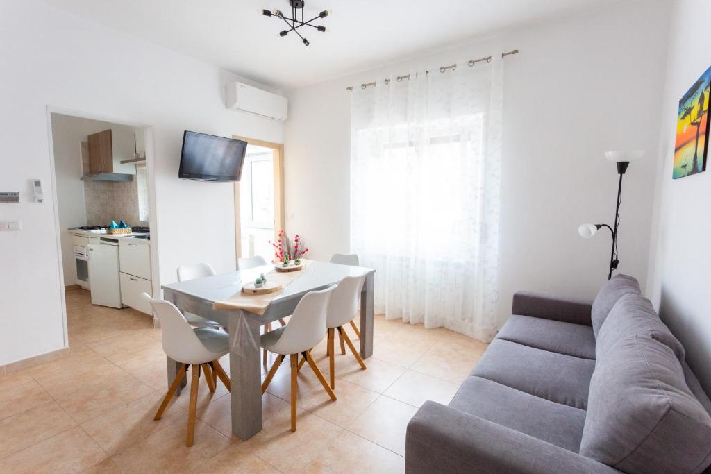 a living room with a table and a couch at Casa Rachele in Porto San Giorgio