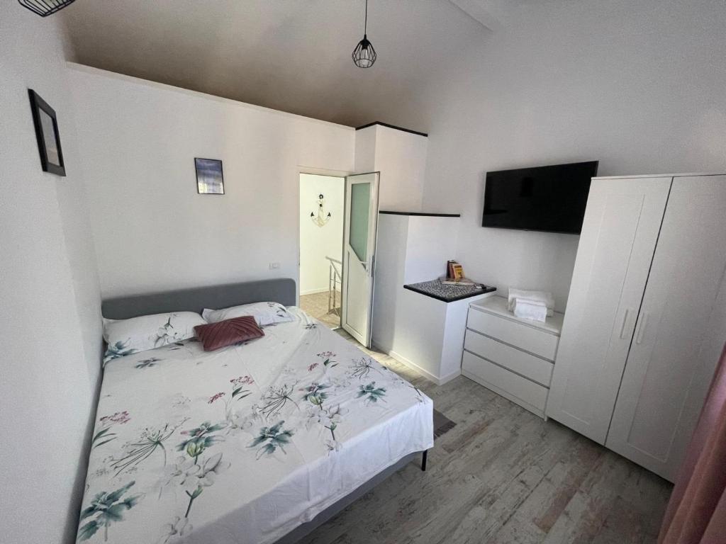 a bedroom with a bed and a flat screen tv at LaNoi 26 in Mangalia
