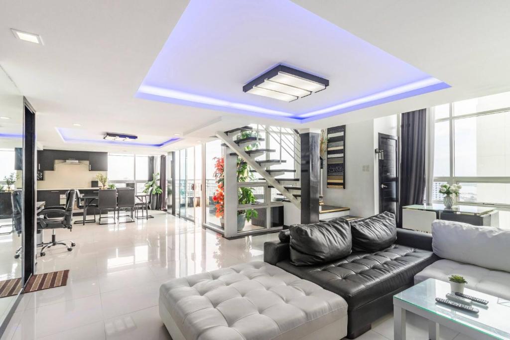 a living room with a couch and a table at Elegance - Ultima Residences in Cebu City