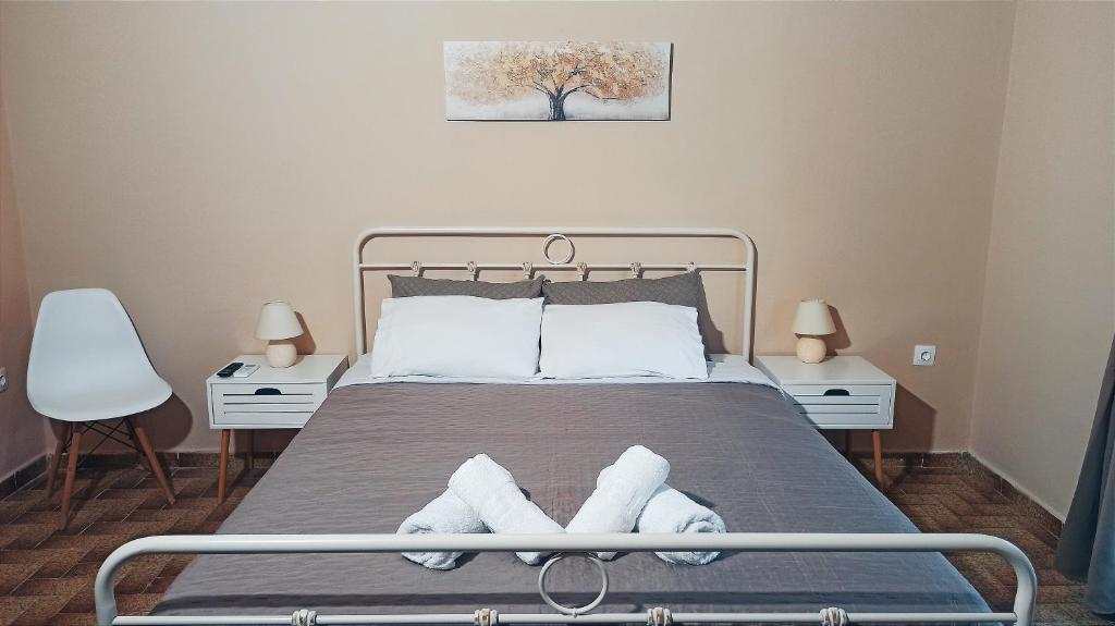 a bedroom with a bed with two towels on it at Lydia's House in Corfu Town