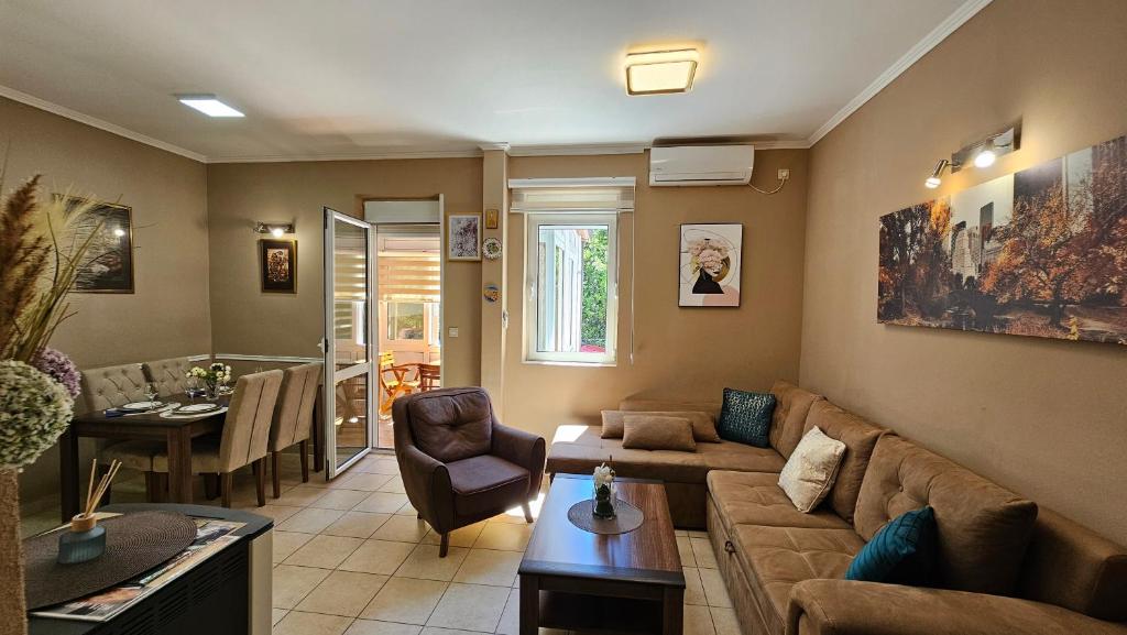 a living room with a couch and a table at Lalovina Apartment in Herceg-Novi