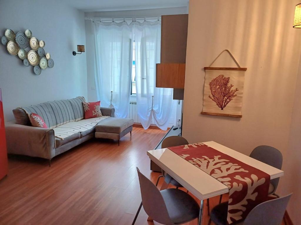 a living room with a couch and a table at Casa Sirio -Rapallo in Rapallo