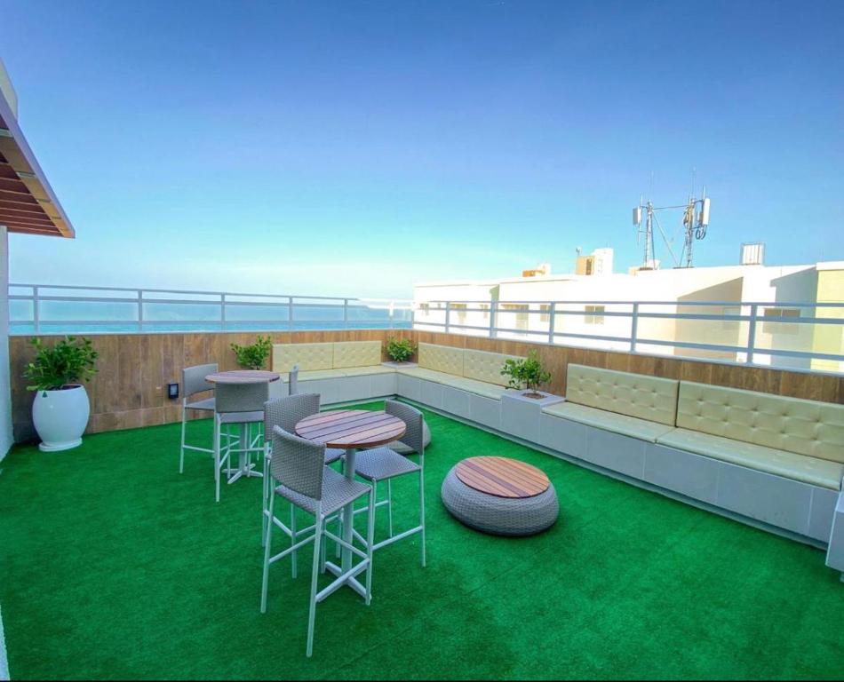 a rooftop patio with chairs and tables on a balcony at Cantinho Praia do Futuro in Fortaleza