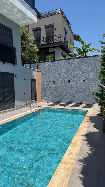 a swimming pool in front of a building at Villa Mia - 4 km to the sea 9 km to the airport in YeÅŸilkÃ¶y