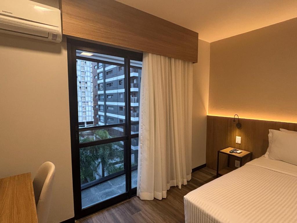 Ένα ή περισσότερα κρεβάτια σε δωμάτιο στο Flat no Edifício Interative Jardins by InnSide - 5 min da Av Paulista