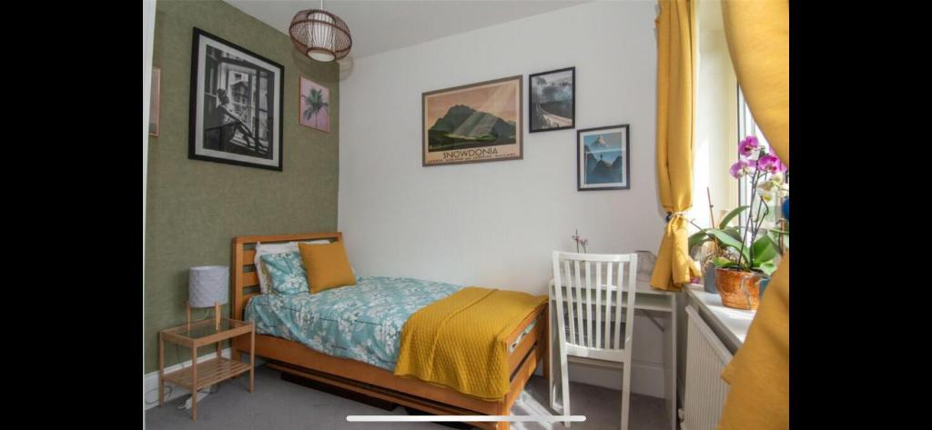 a small bedroom with a bed and a crib at Cosy & Comfortable in Birmingham