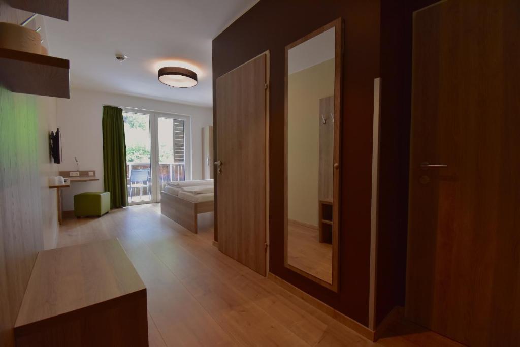 A bed or beds in a room at Sporthotel Zederhaus im Lungau