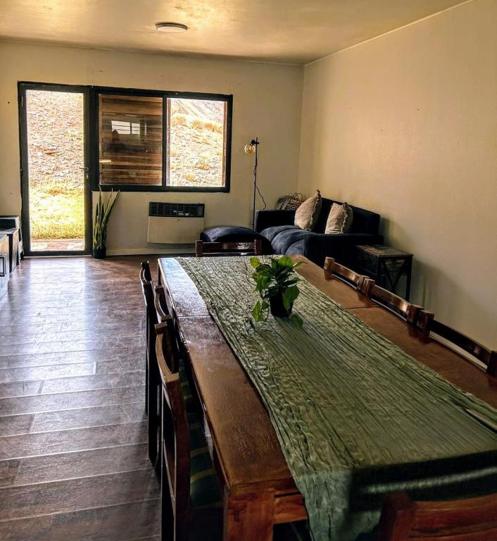a living room with a table and a couch at Los penitentes, edificio juncal dpto 1 in Los Penitentes