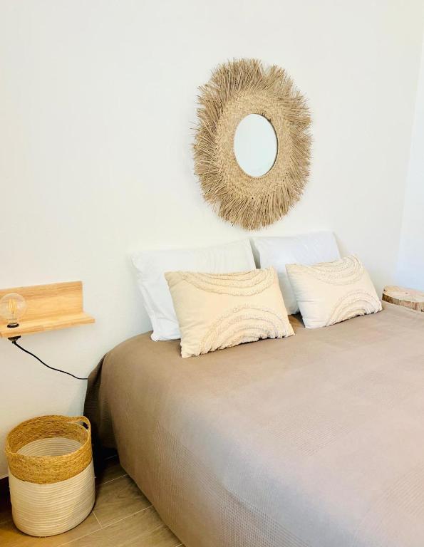 a bedroom with a bed with a mirror on the wall at Casa Fidalgo in Santo António da Terrugem