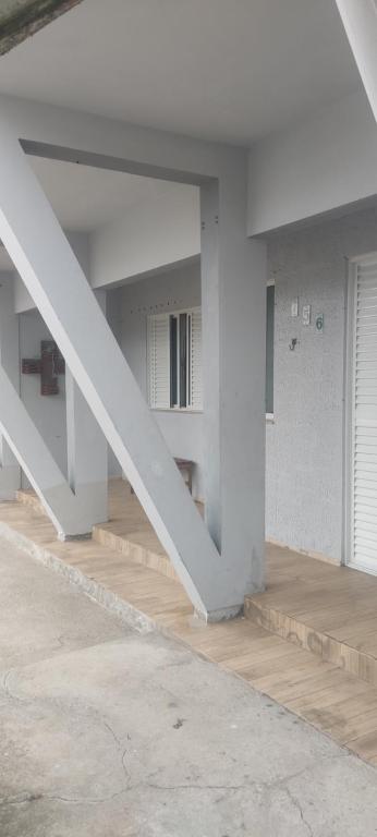 a white room with a staircase in a building at Casa Lagoa Santo Antônio in Laguna