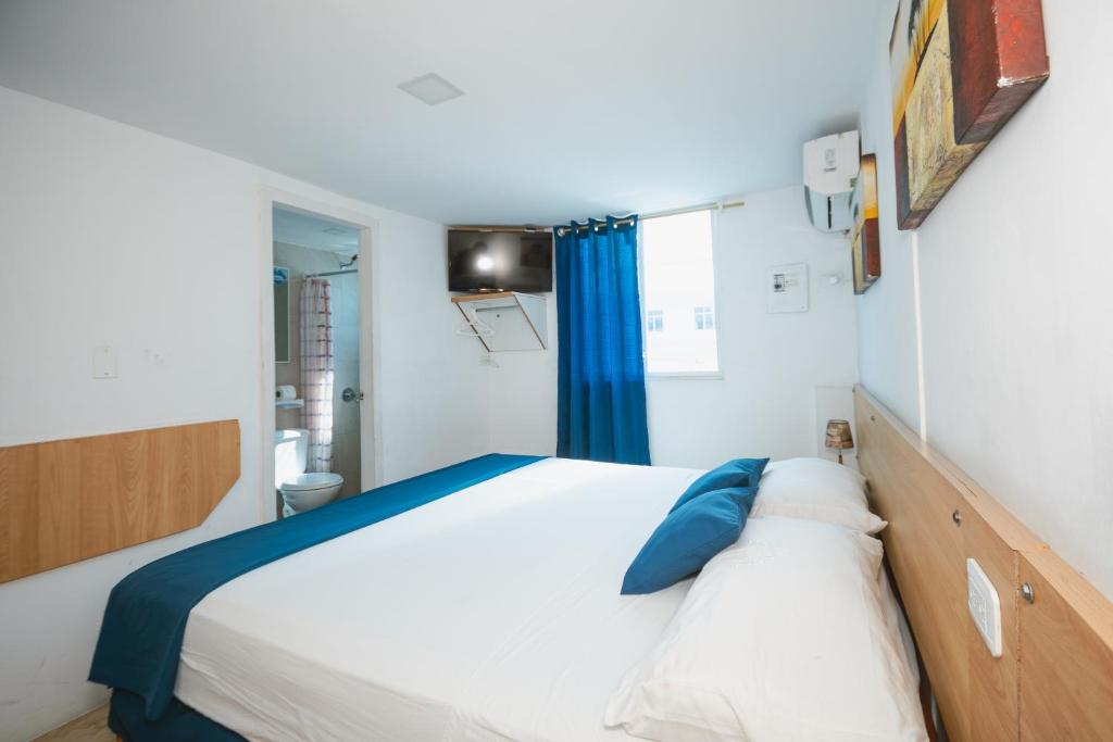 Postel nebo postele na pokoji v ubytování Hotel Casa Latina