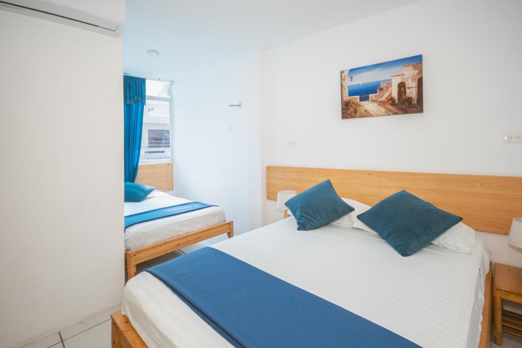 Postel nebo postele na pokoji v ubytování Hotel Casa Latina