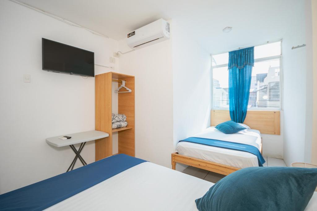 Postel nebo postele na pokoji v ubytování Hotel Casa Latina