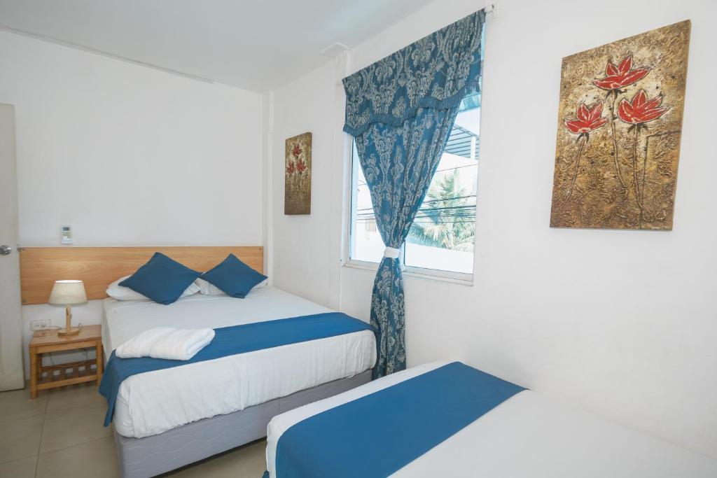 Postel nebo postele na pokoji v ubytování Hotel Casa Latina