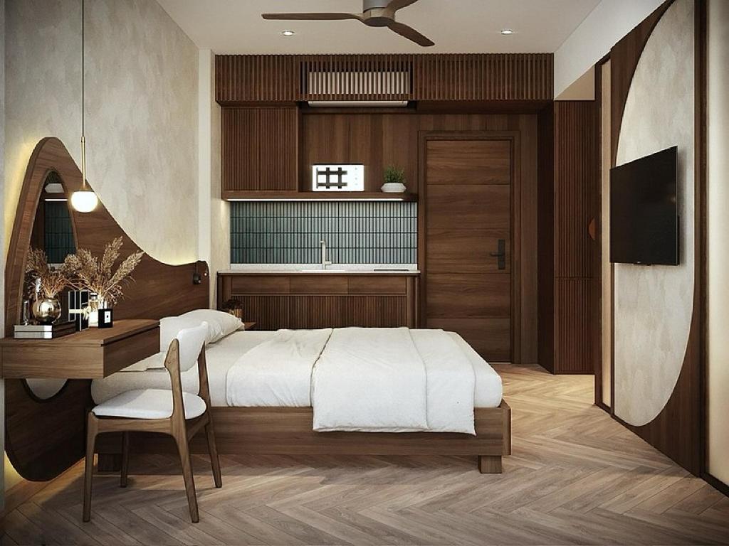 a bedroom with a bed and a desk and a television at Hans Hotel in Da Nang