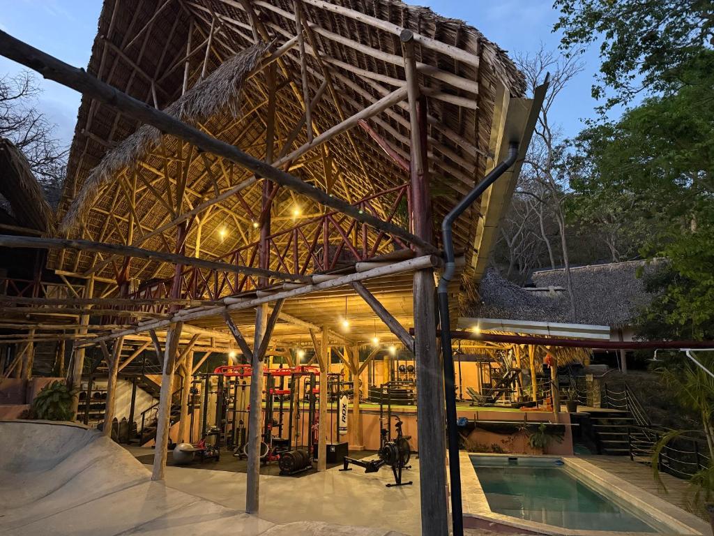 ein Gebäude mit einem Pool davor in der Unterkunft Its a Lifestyle Rancho Room in San Juan del Sur