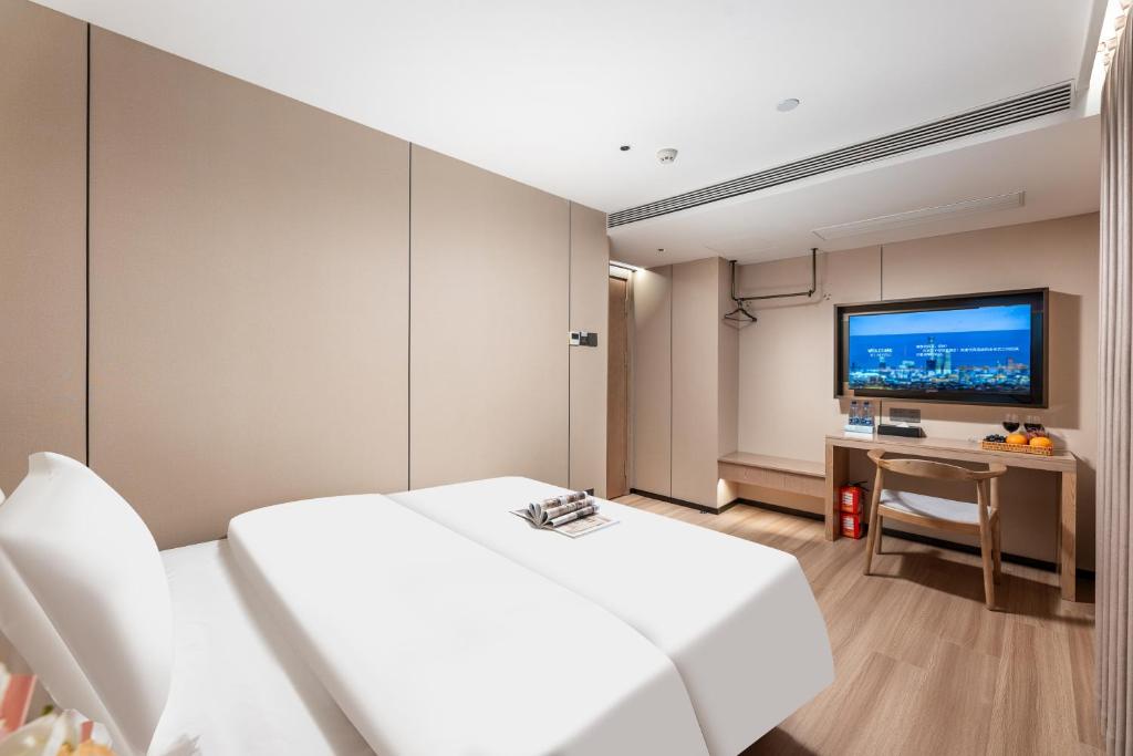 TV a/nebo společenská místnost v ubytování Guangzhou JinTang Hotel