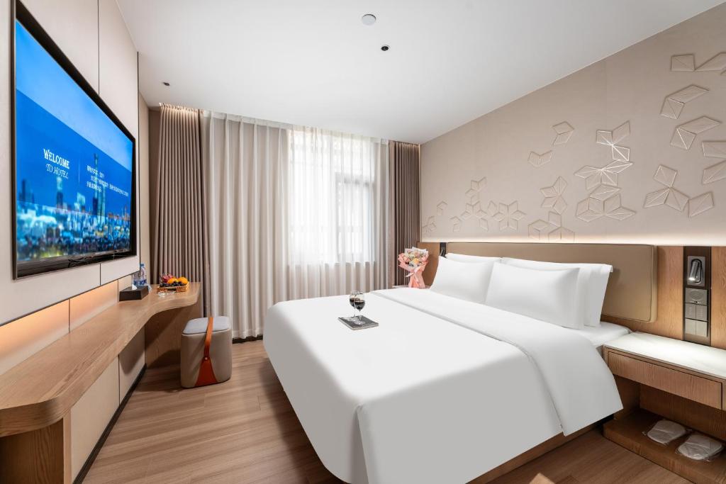Postel nebo postele na pokoji v ubytování Guangzhou JinTang Hotel