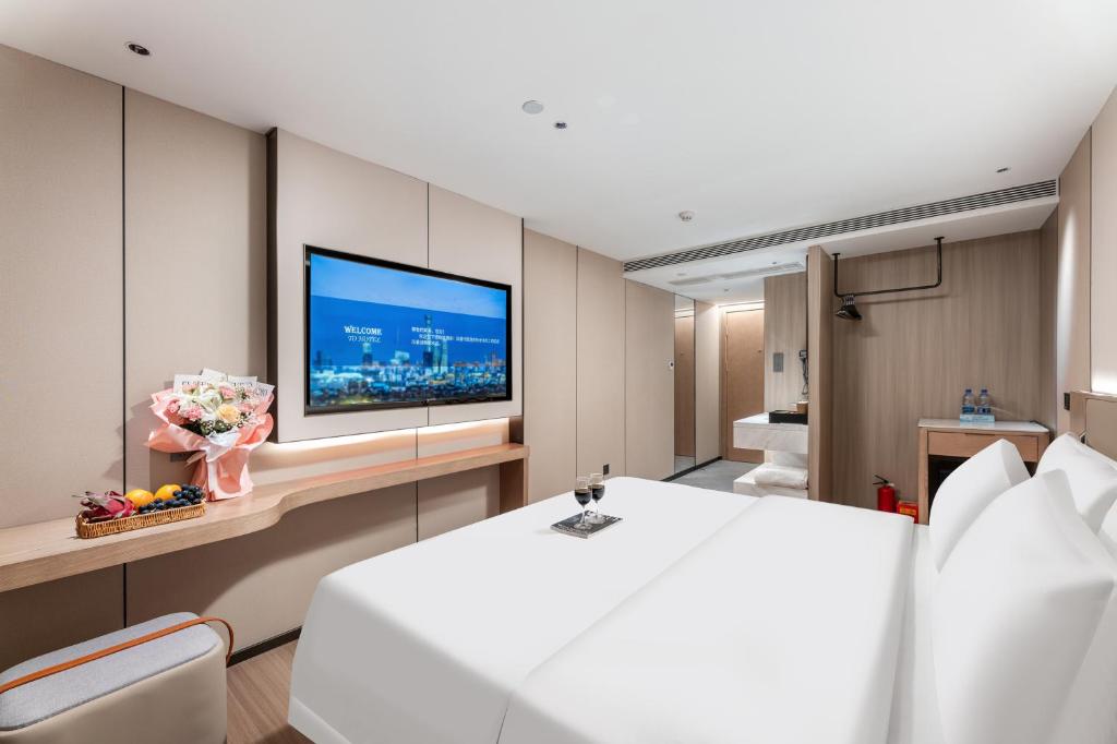 Postel nebo postele na pokoji v ubytování Guangzhou JinTang Hotel