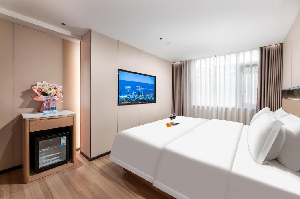 Postel nebo postele na pokoji v ubytování Guangzhou JinTang Hotel