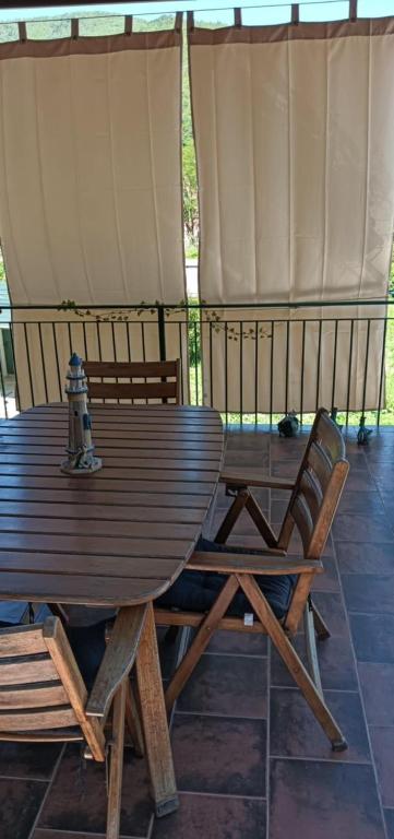 a wooden table and chairs on a patio at Da Ange e Bru in Sestri Levante