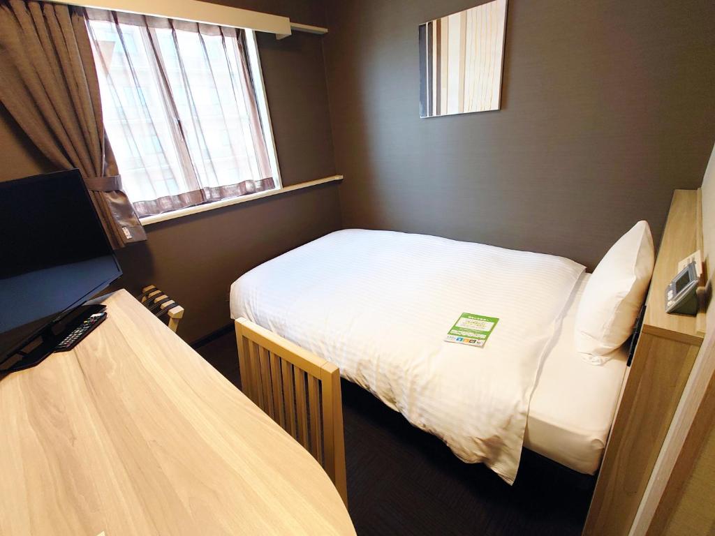 Postel nebo postele na pokoji v ubytování Hotel Route Inn Matsue