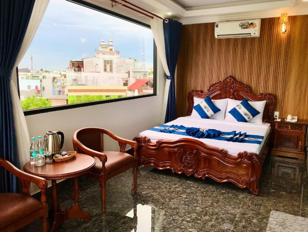 a bedroom with a bed and a window at Cozy 86 Homestay in Can Tho