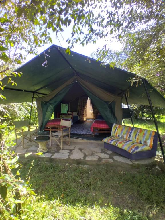 a green tent with couches and a table at Best Camping Tours Campsite in Masai Mara