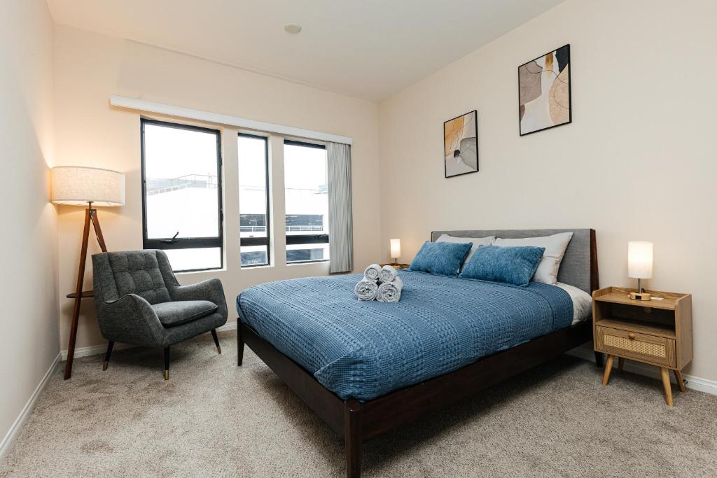 a bedroom with a bed and a chair and a window at Stunning 2 bedroom near by The Grove in Los Angeles