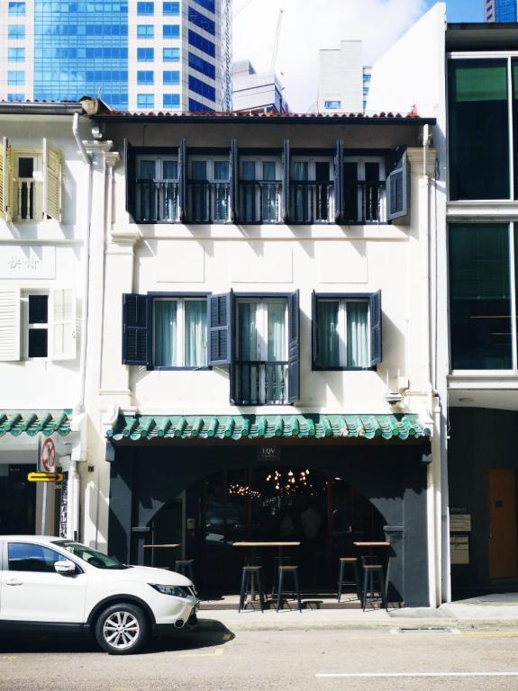 a white car parked in front of a building at Heritage Collection on Boon Tat in Singapore