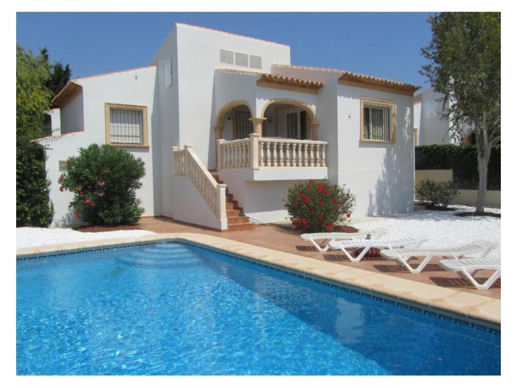 a villa with a swimming pool in front of a house at Villas Monte Jávea - BTB in Jávea