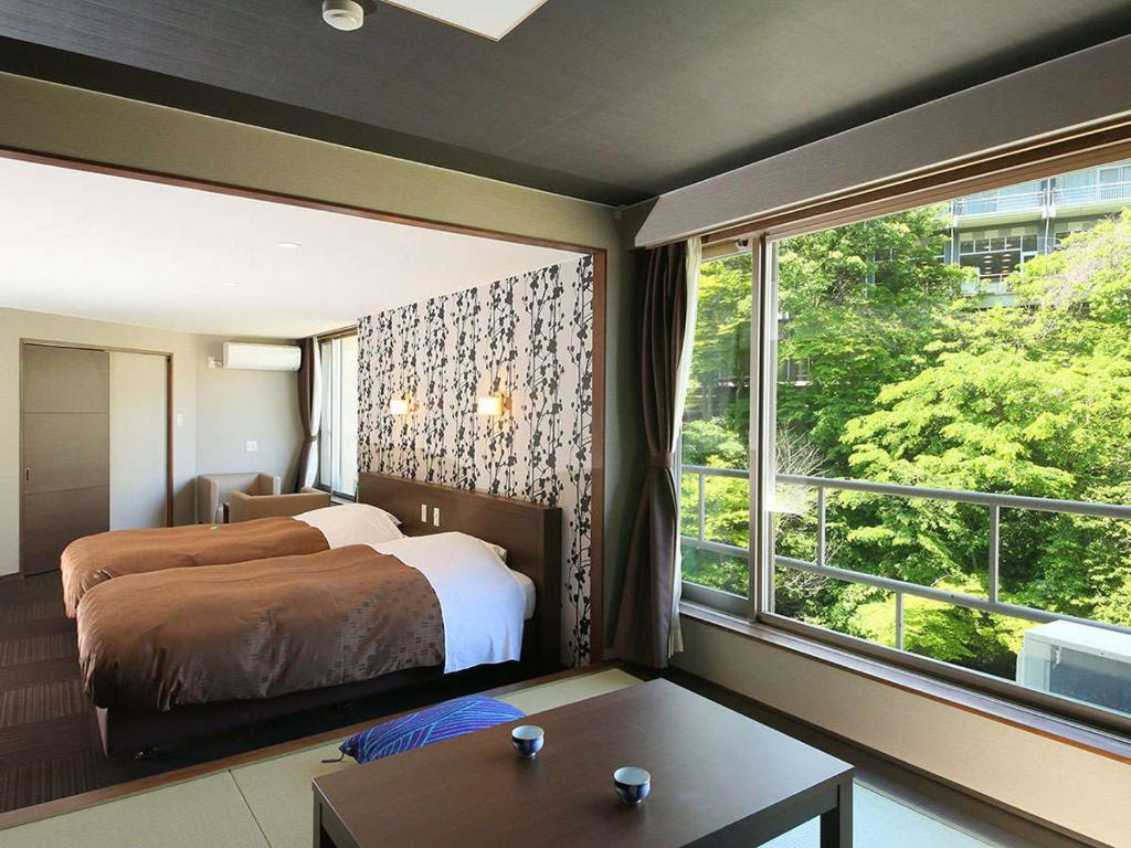 Postel nebo postele na pokoji v ubytování Ooedo Onsen Monogatari Premium Hotel New Shiobara