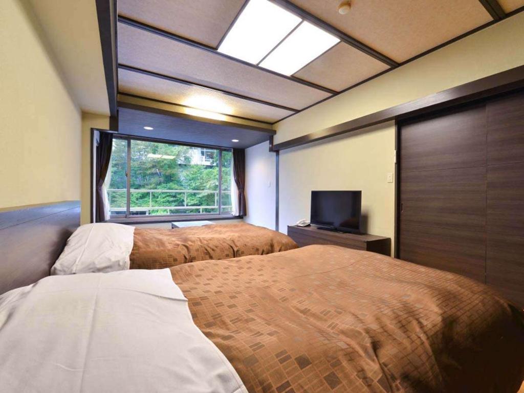Postel nebo postele na pokoji v ubytování Ooedo Onsen Monogatari Premium Hotel New Shiobara