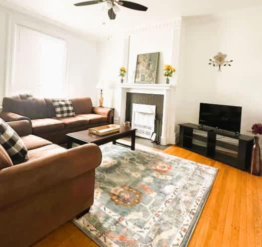 a living room with a couch and a fireplace at Stunning 3BR-Private Entrance-Renovated-Near City in Pittsburgh