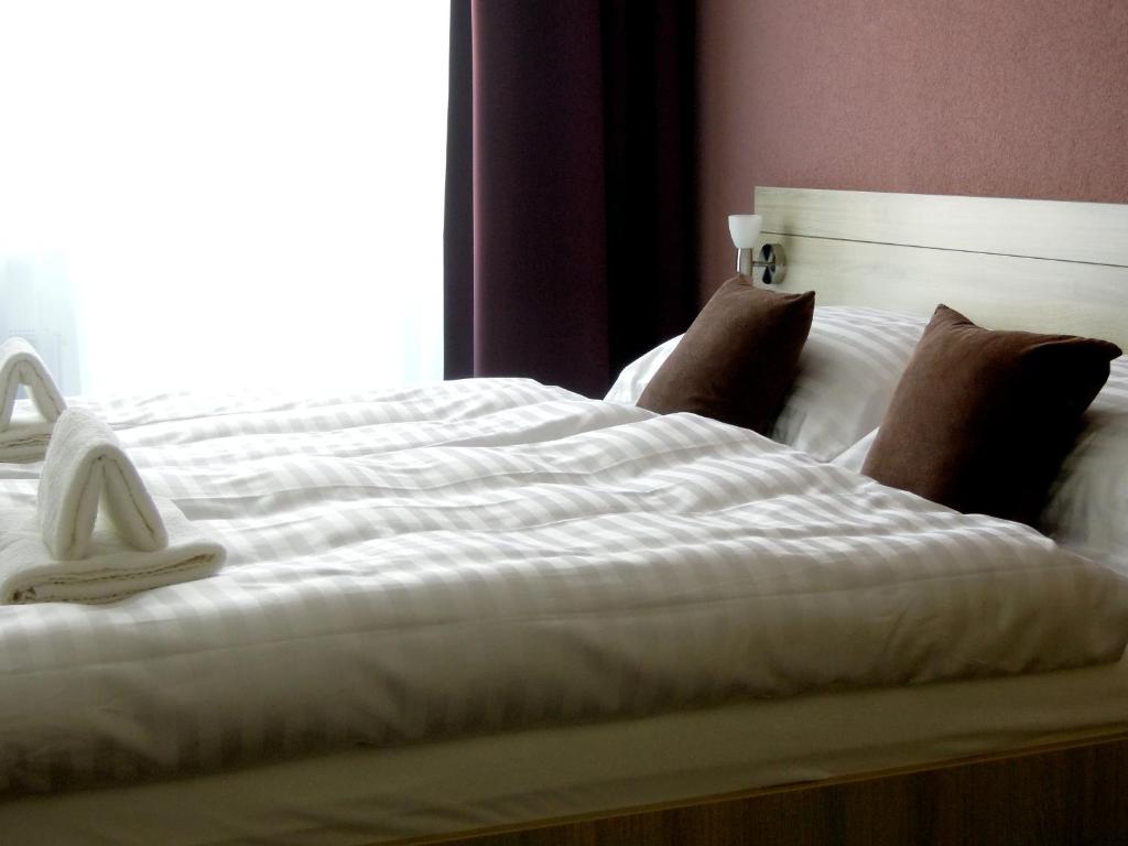 Postel nebo postele na pokoji v ubytování Hotel Kristína