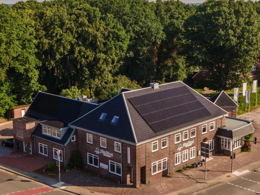 an aerial view of a house with a solar roof at Ferienwohnung im Hotel Preyt 35228 in Holtlander Nücke