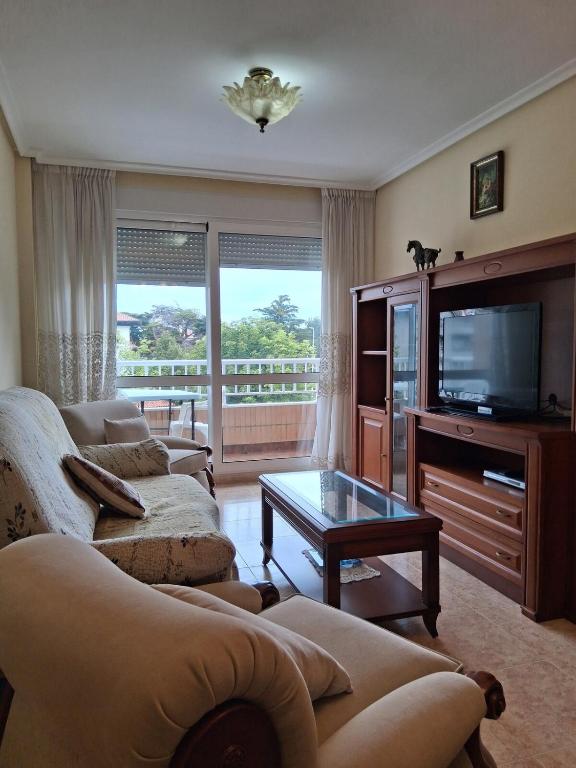 a living room with two couches and a television at R2R - Apartamento en Noja 2 dormitorios - C18A02 in Noja