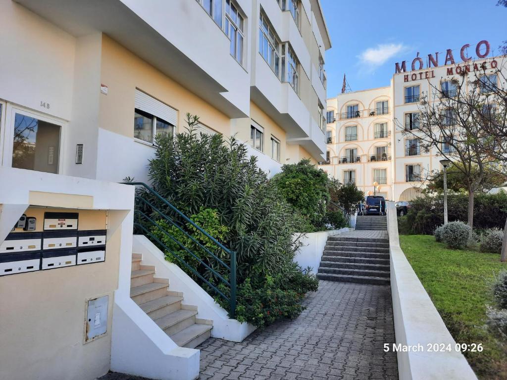 a building with stairs in front of it at Blife Candya private rooms in Faro