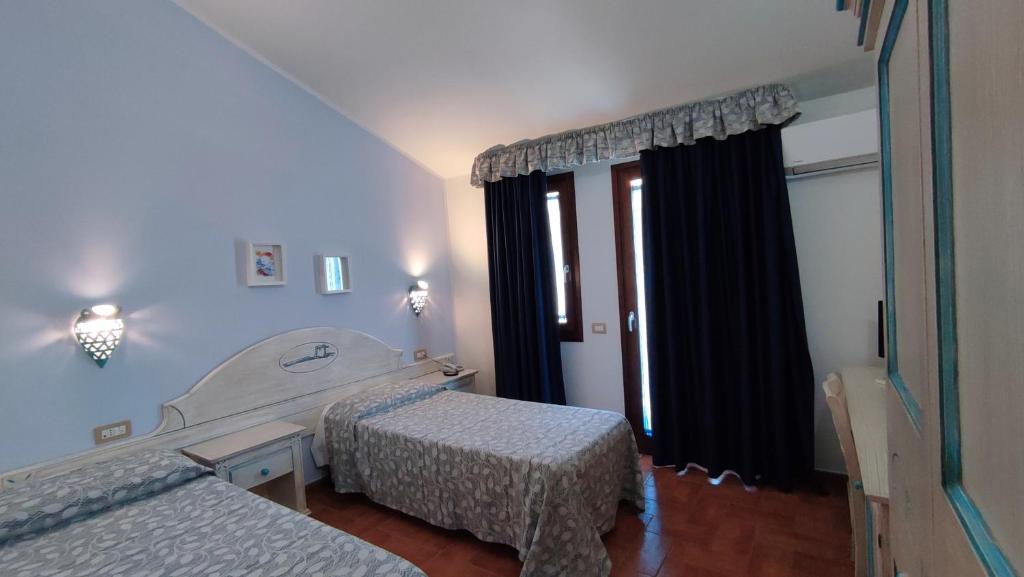 Postel nebo postele na pokoji v ubytování Hotel le Sabbie
