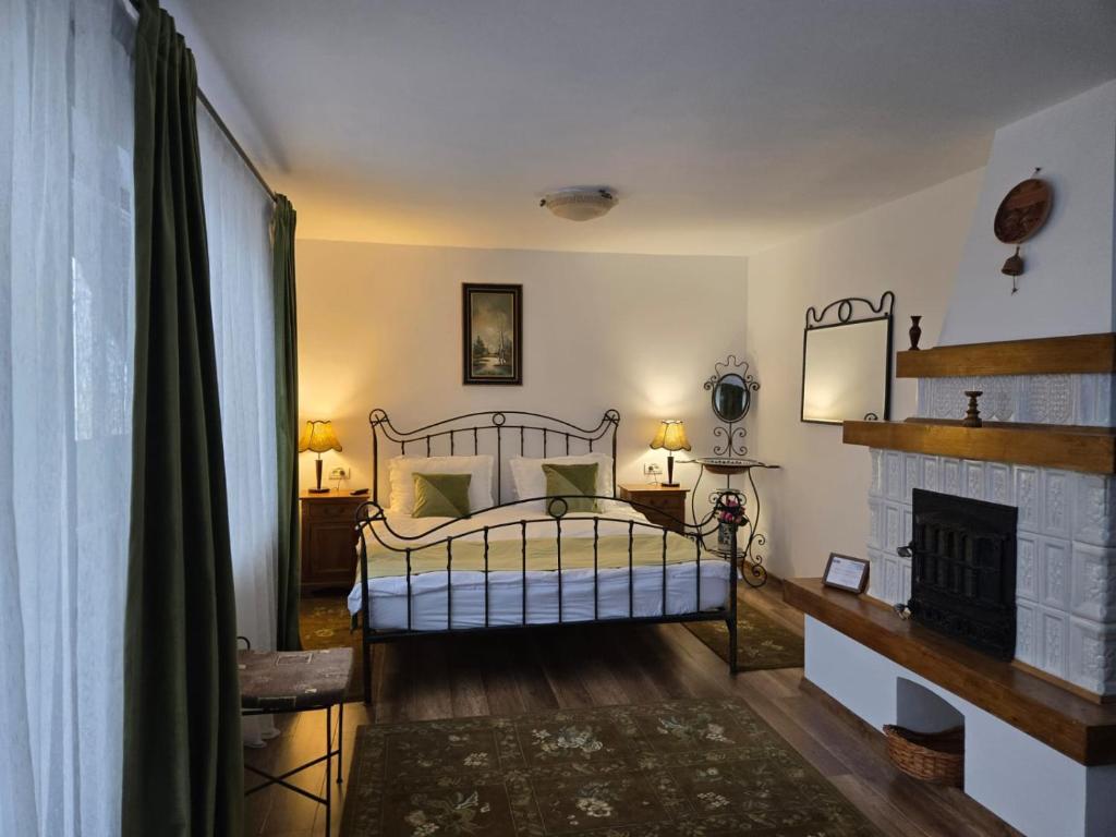 a bedroom with a bed and a fireplace at DRUMUL DOMNISORILOR c in Buşteni