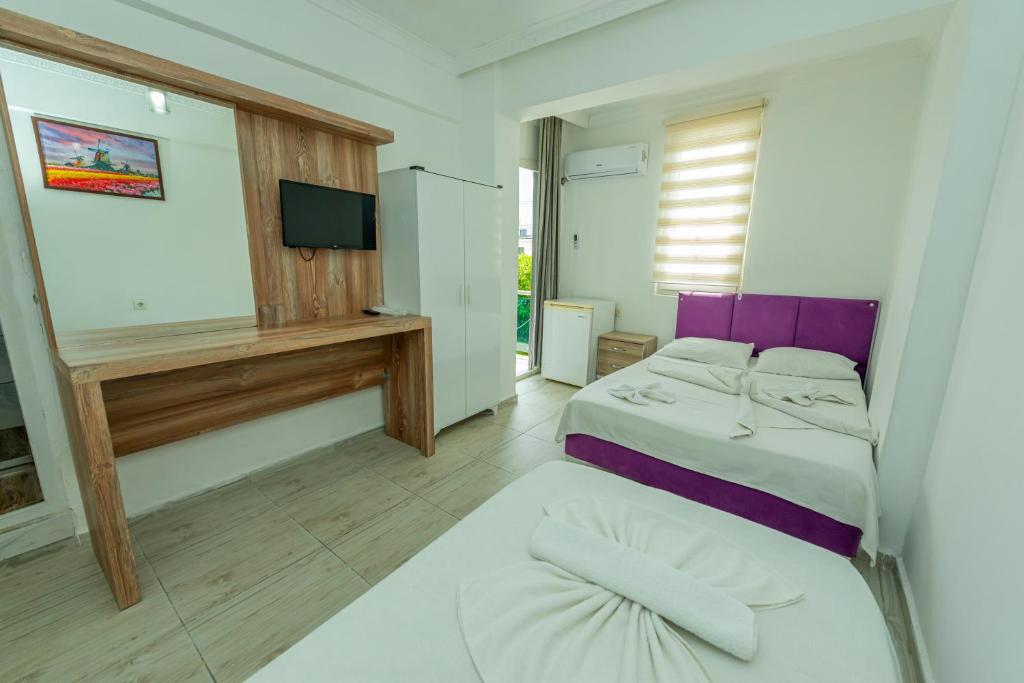 Postel nebo postele na pokoji v ubytování Aliş Hotel Fethiye