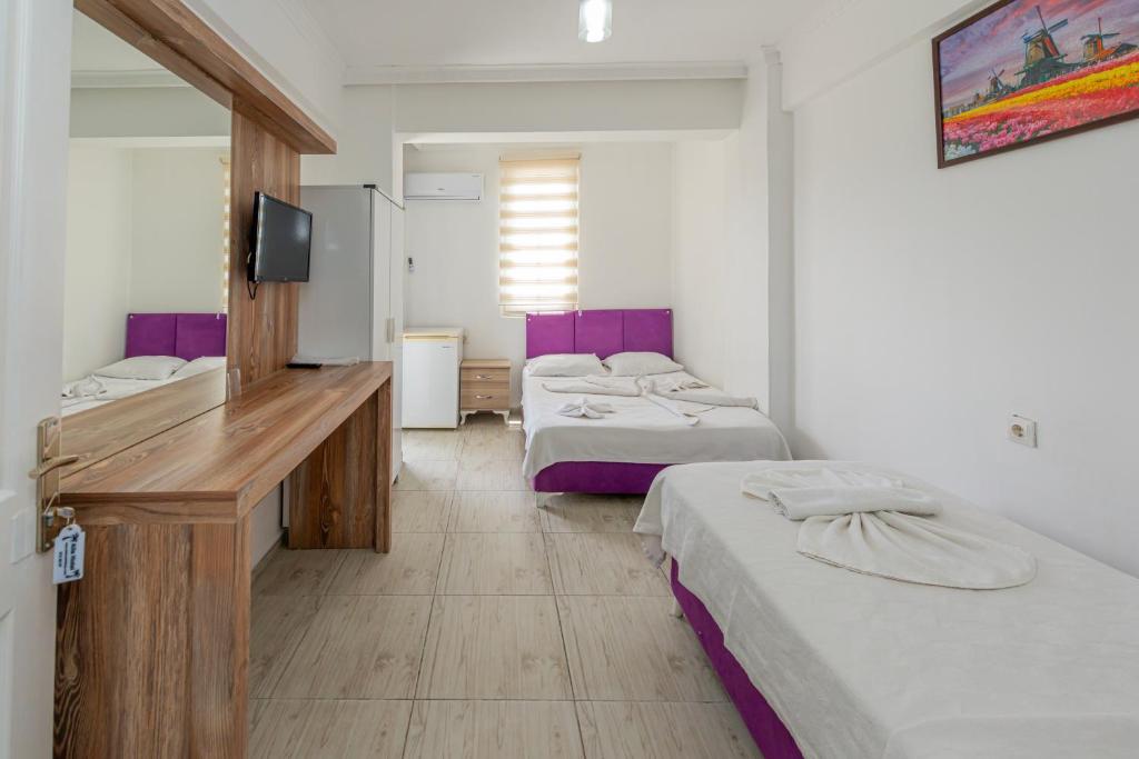 Postel nebo postele na pokoji v ubytování Aliş Hotel Fethiye